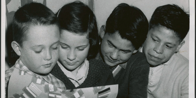Non-Indigenous and Indigenous children reading a book