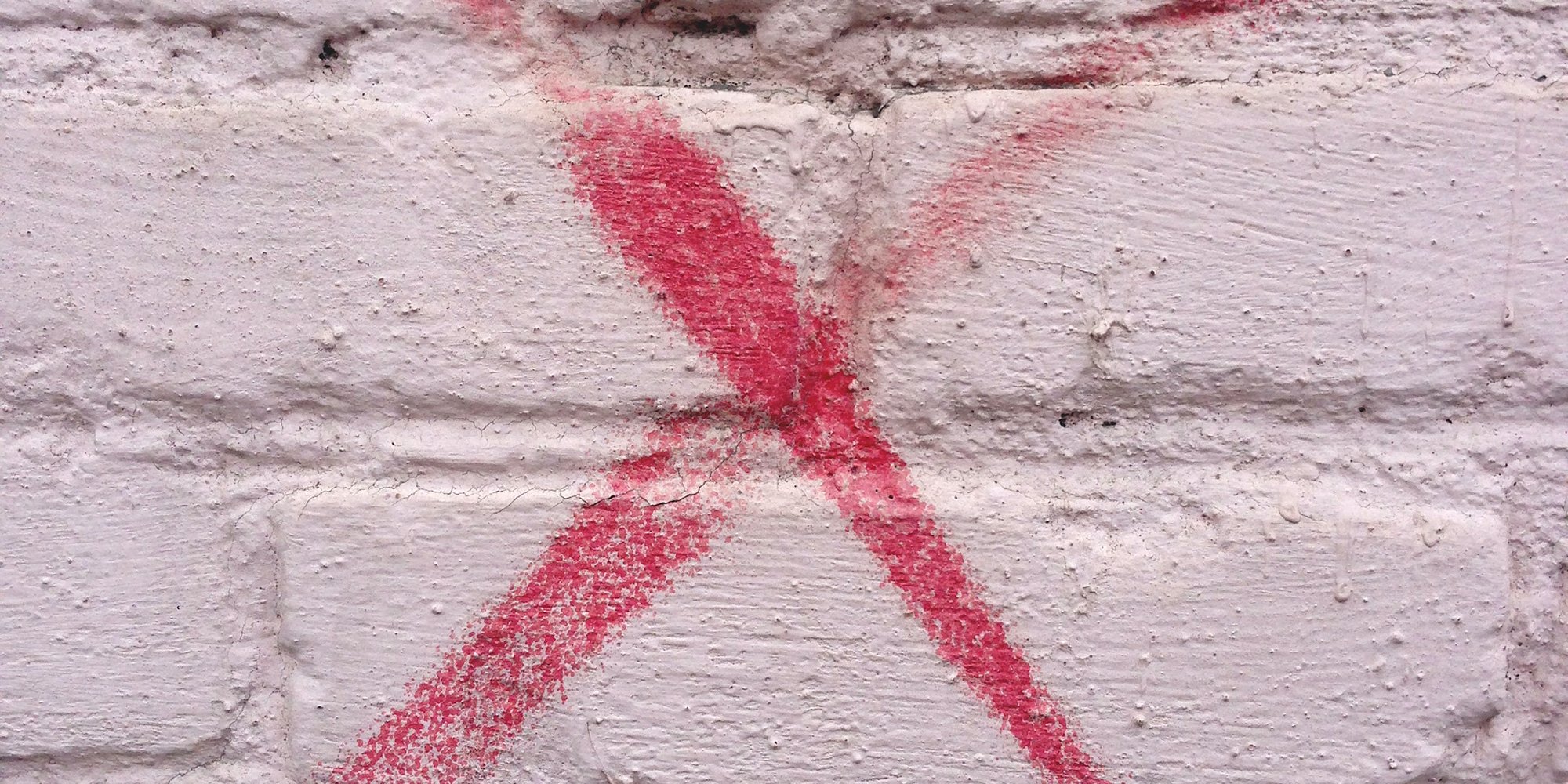 X sprayed on a wall