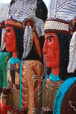 culturally insensitive wooden indians in front of cigar store
