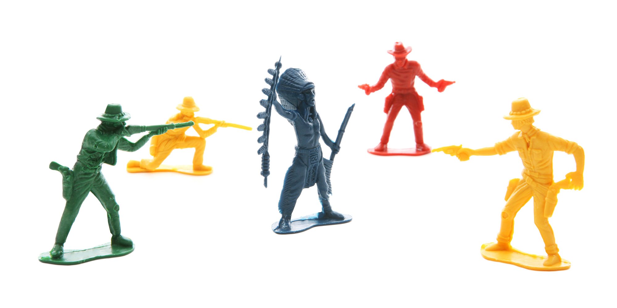 "Several cowboys aiming their guns at an Indian"