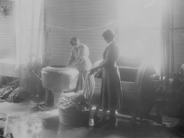 Two female students working in the laundry room, Brandon Indian Residential School, 1920. Photo:LAC PA-048572