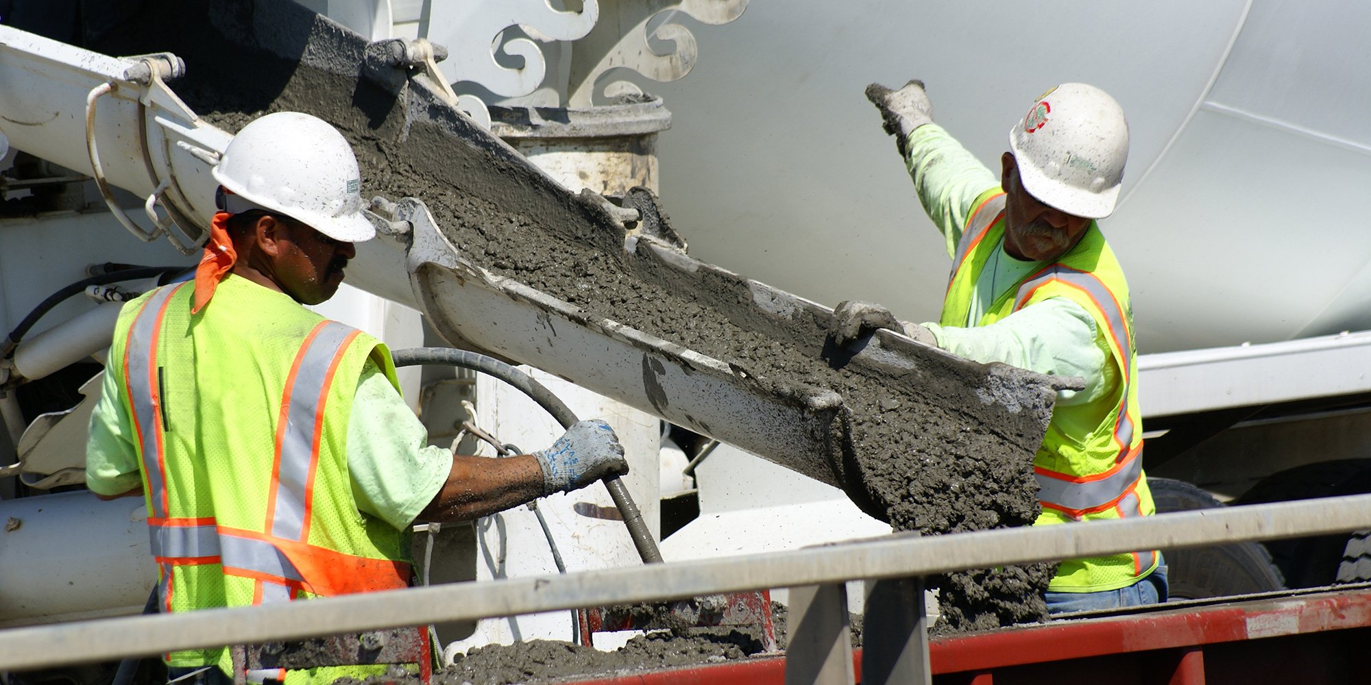 construction workers pouring cement