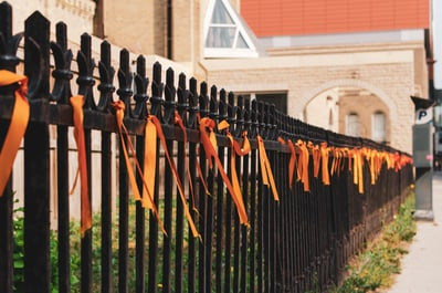 orange ribbons tied to a wrought iron fence outside Saint Mary's Cathedral, Winnipeg, Manitoba, Canada