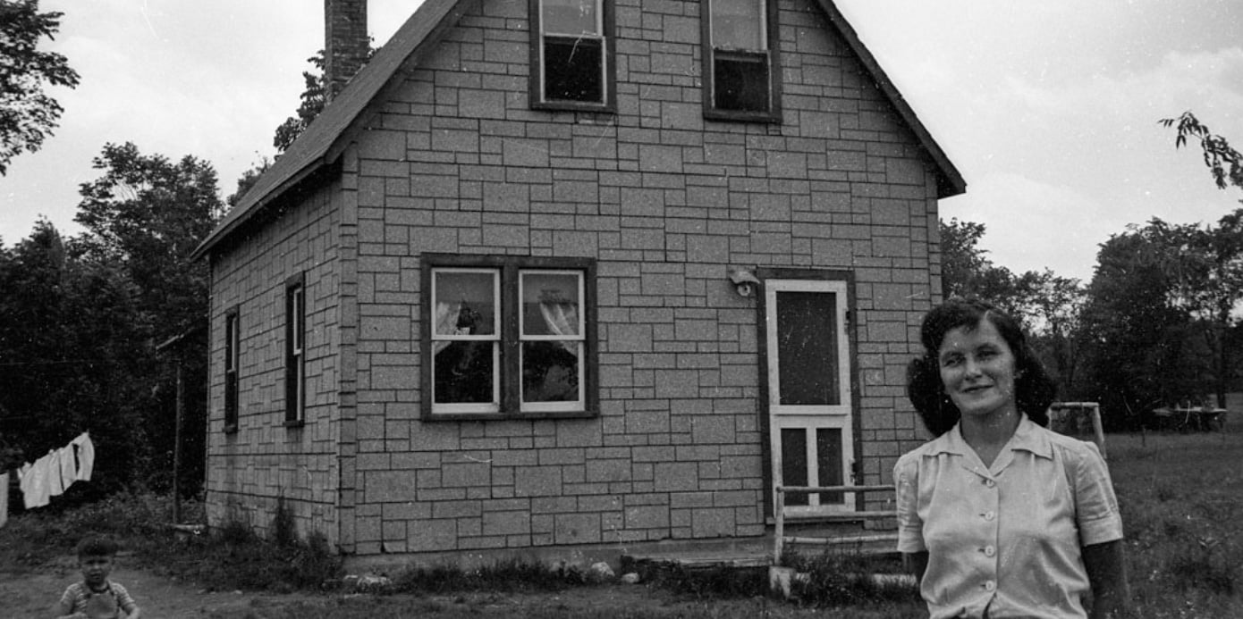 woman and chief standing in front of reserve house