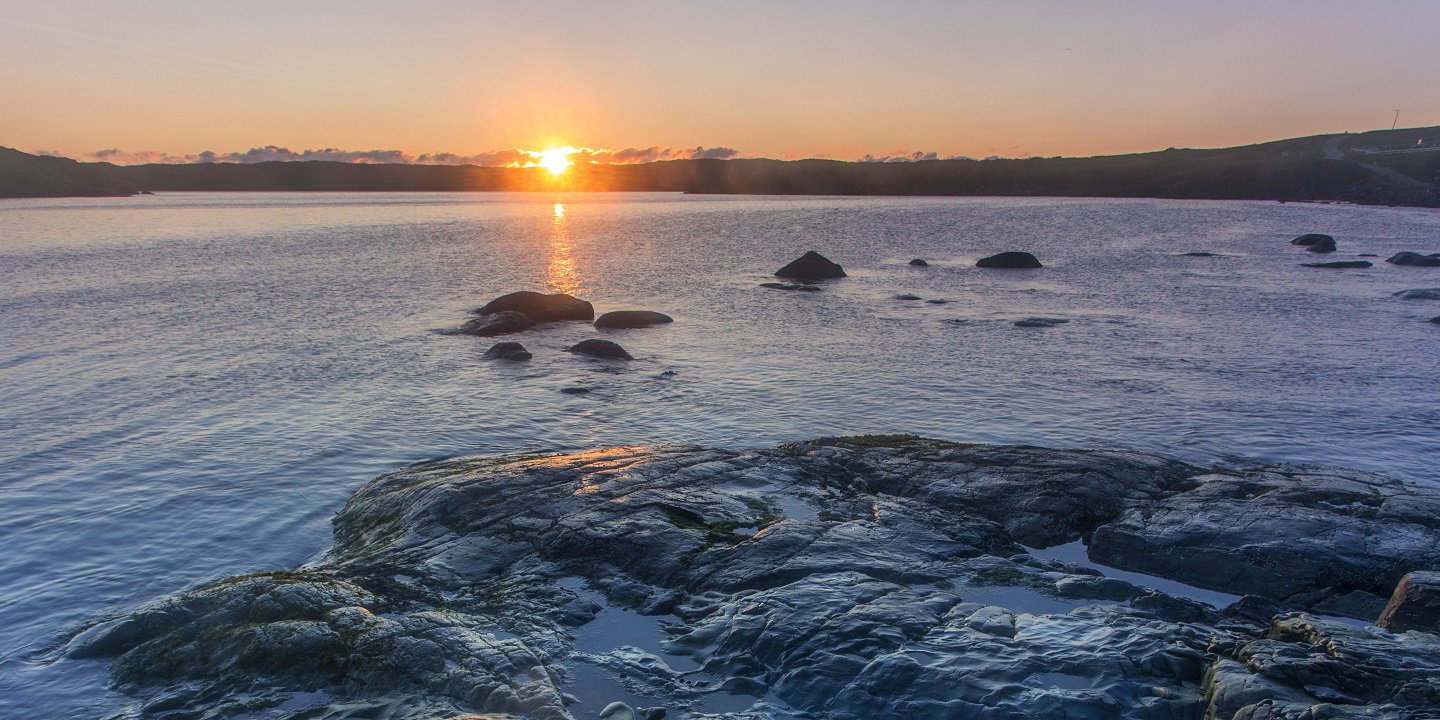 Sunrise with coastal rocks; St. Anthony, Newfoundland