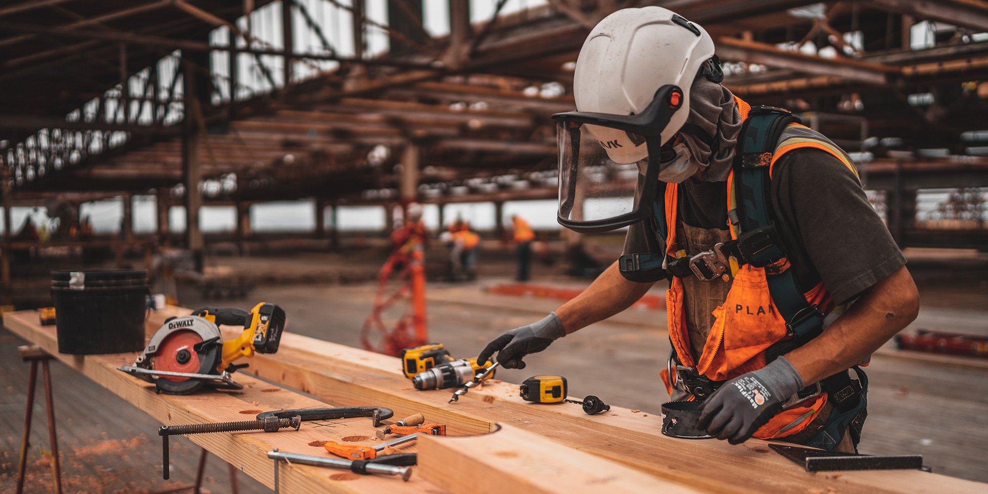 carpenter working on wood on a build site