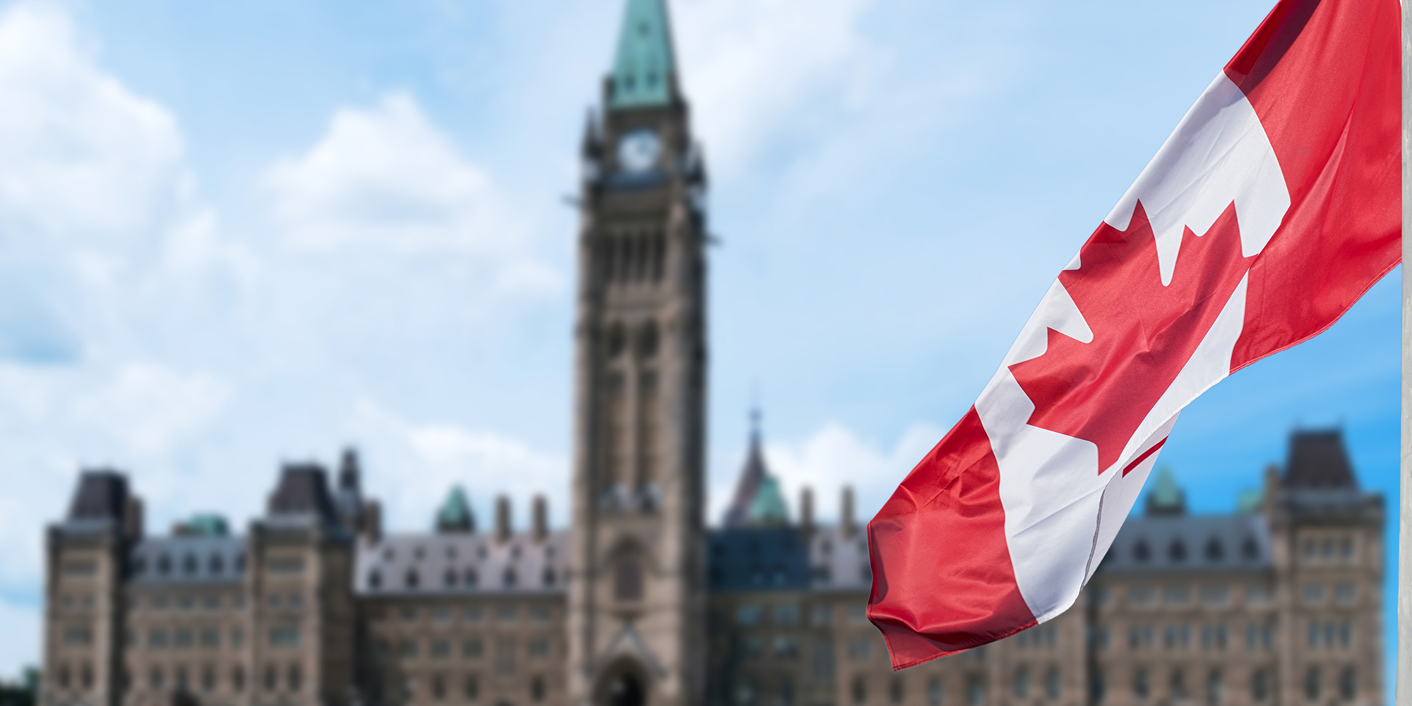 Canadian flag in front of the Parliament buildings