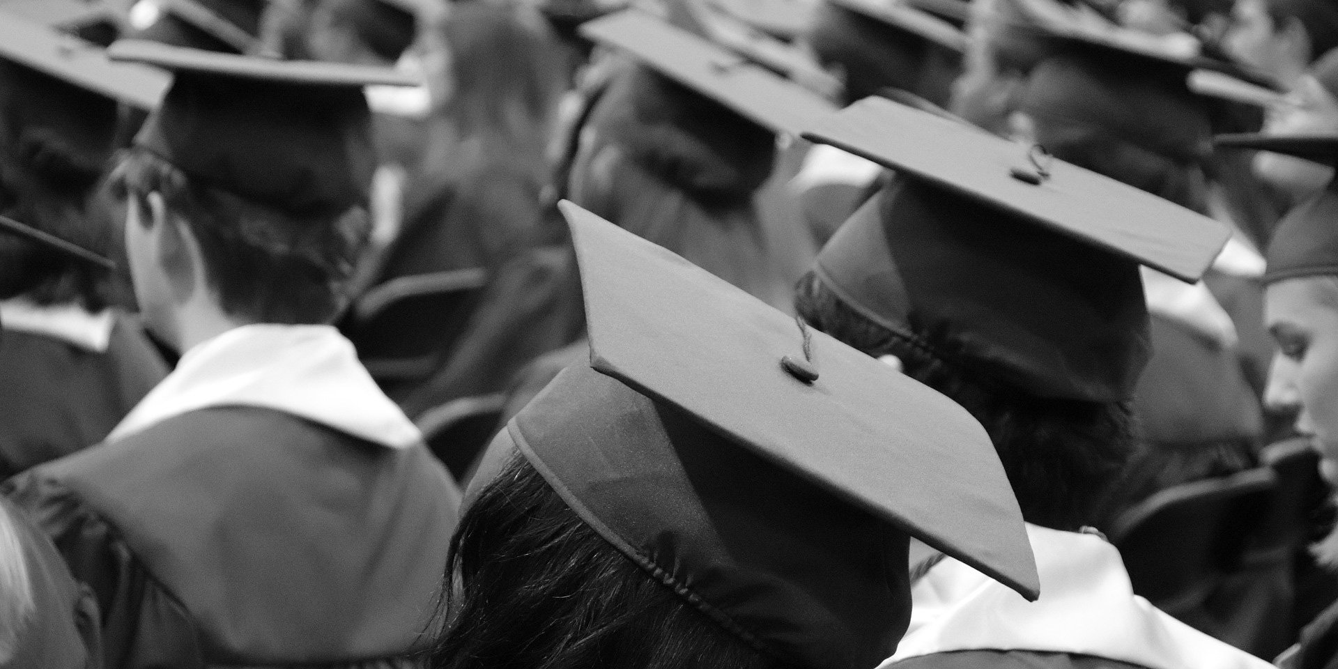 group of students in graduation cap and gowns