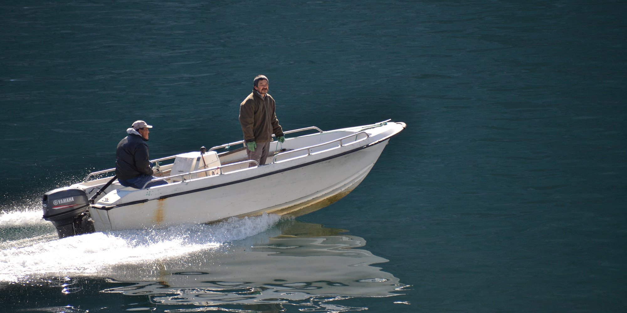 Inuit fishing boat and fishermen