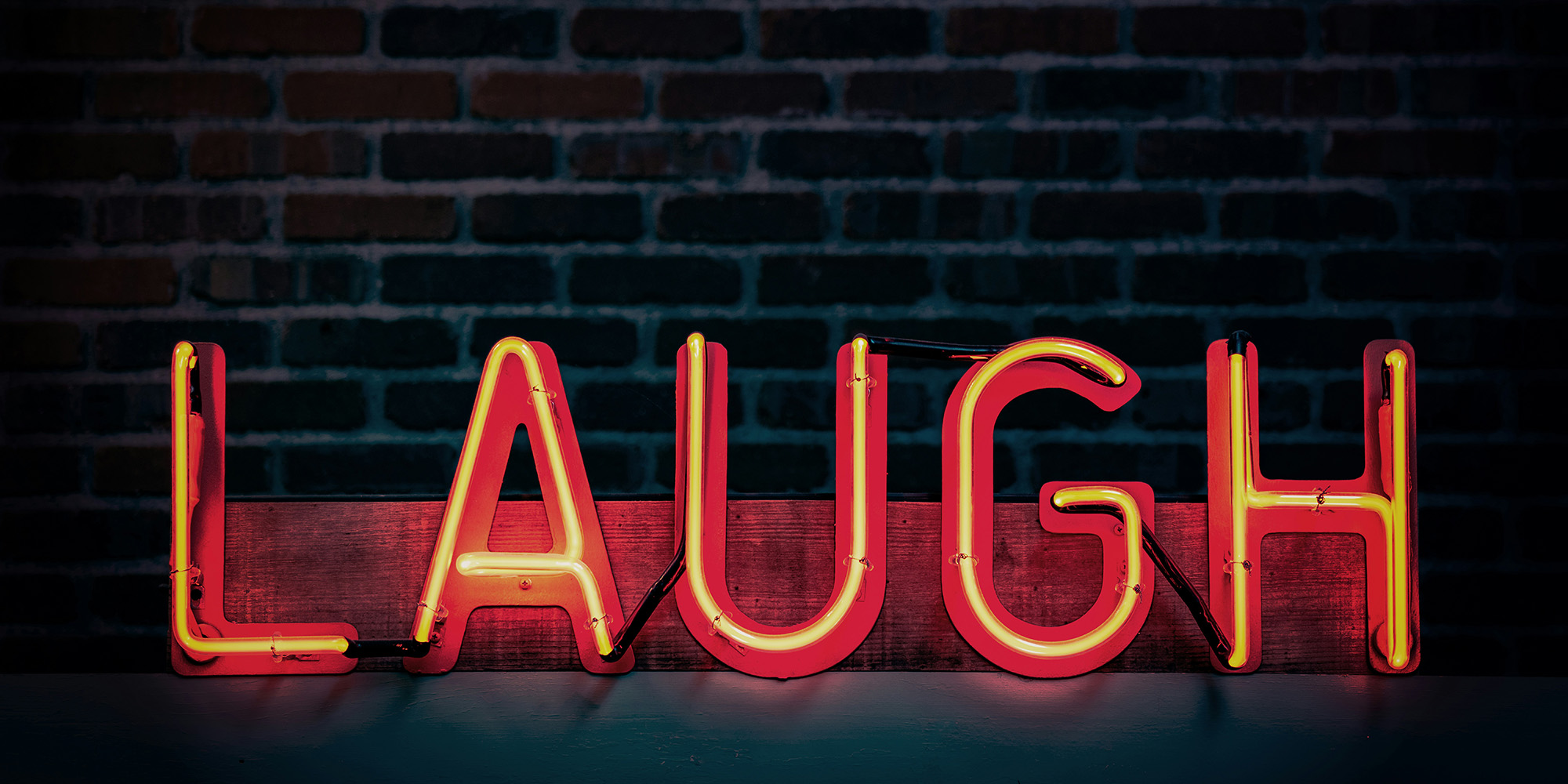 neon sign that says laugh