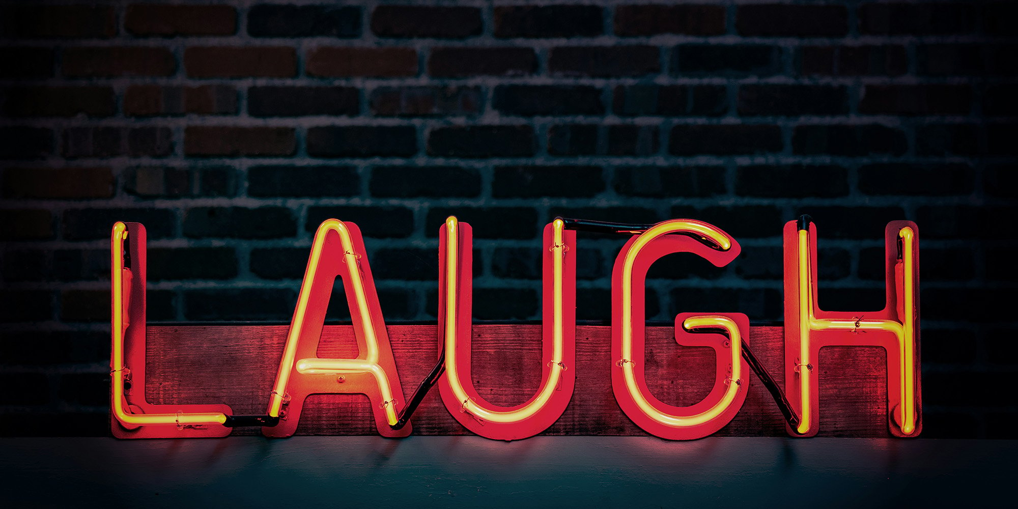 neon sign that says laugh