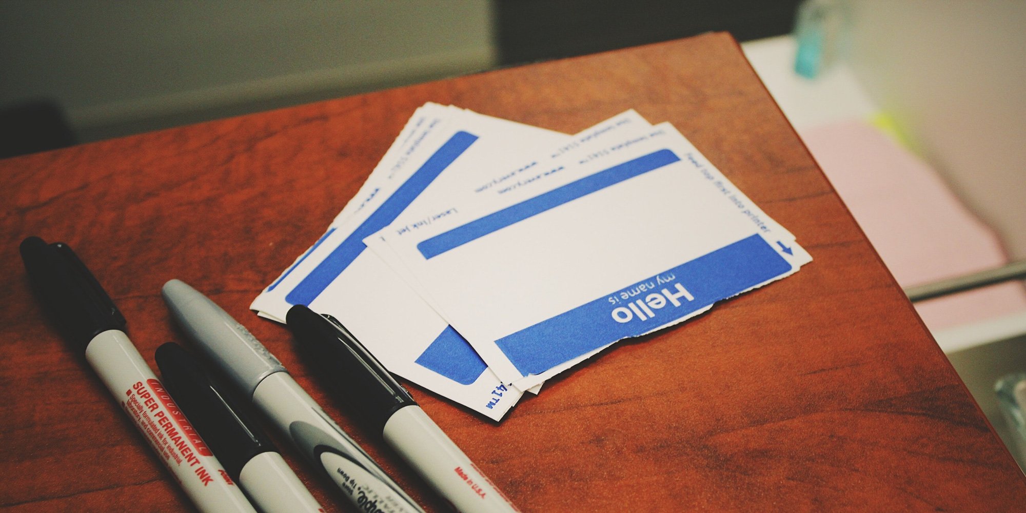 nametags and pens on table