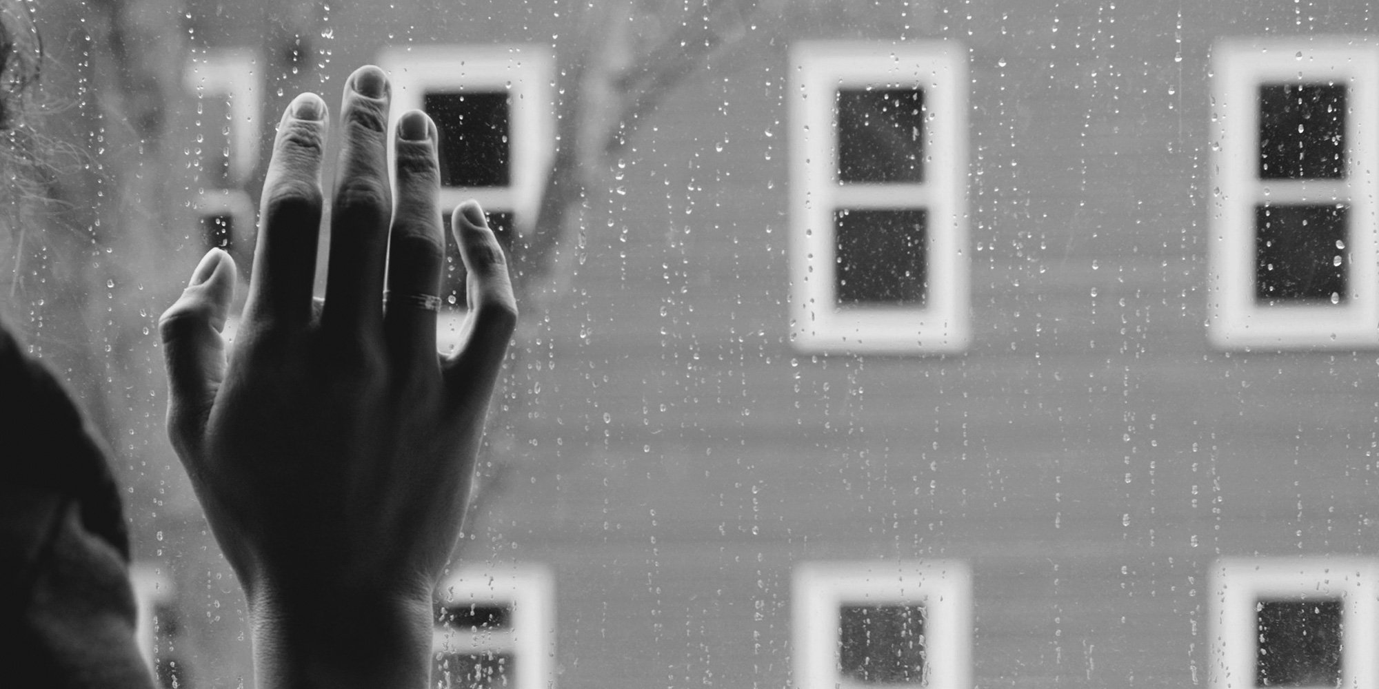 hand on rainy window