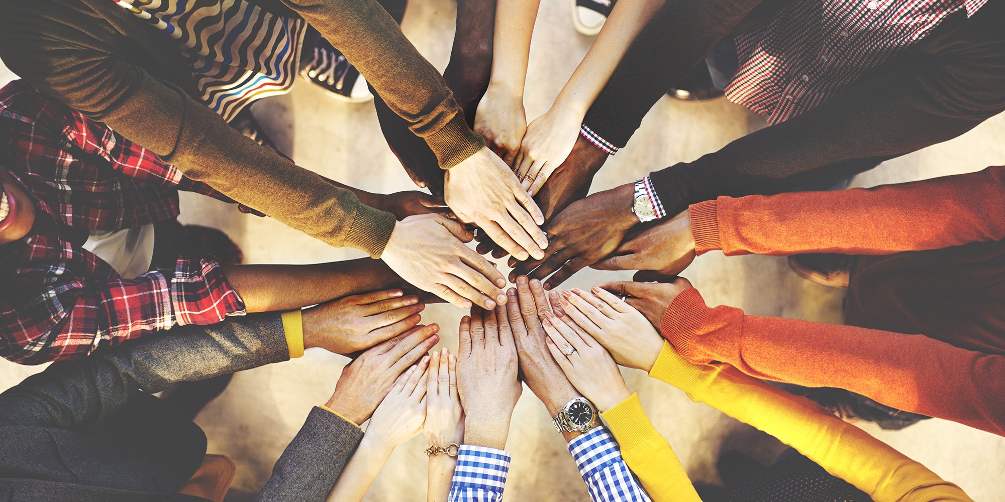 diverse people with hands in a circle